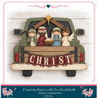 A wooden nativity scene with a car, featuring a man, a woman, and two angels, with the word "CHRIST" displayed on the back of the car.