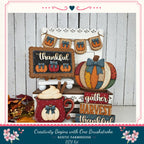 A rustic farmhouse-style DIY kit featuring a variety of fall-themed decorations, including a pumpkin-shaped sign, a pumpkin-shaped mug, and a pumpkin-shaped banner.