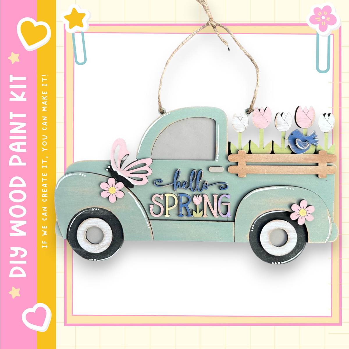 A wooden truck with a floral design and the text "Hello Spring" on it, hanging on a string.