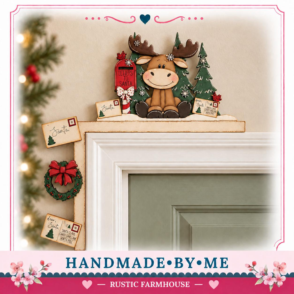 A handmade wooden decoration featuring a moose sitting on a shelf above a door, with Christmas-themed elements such as a wreath, a Santa card, and a postcard.