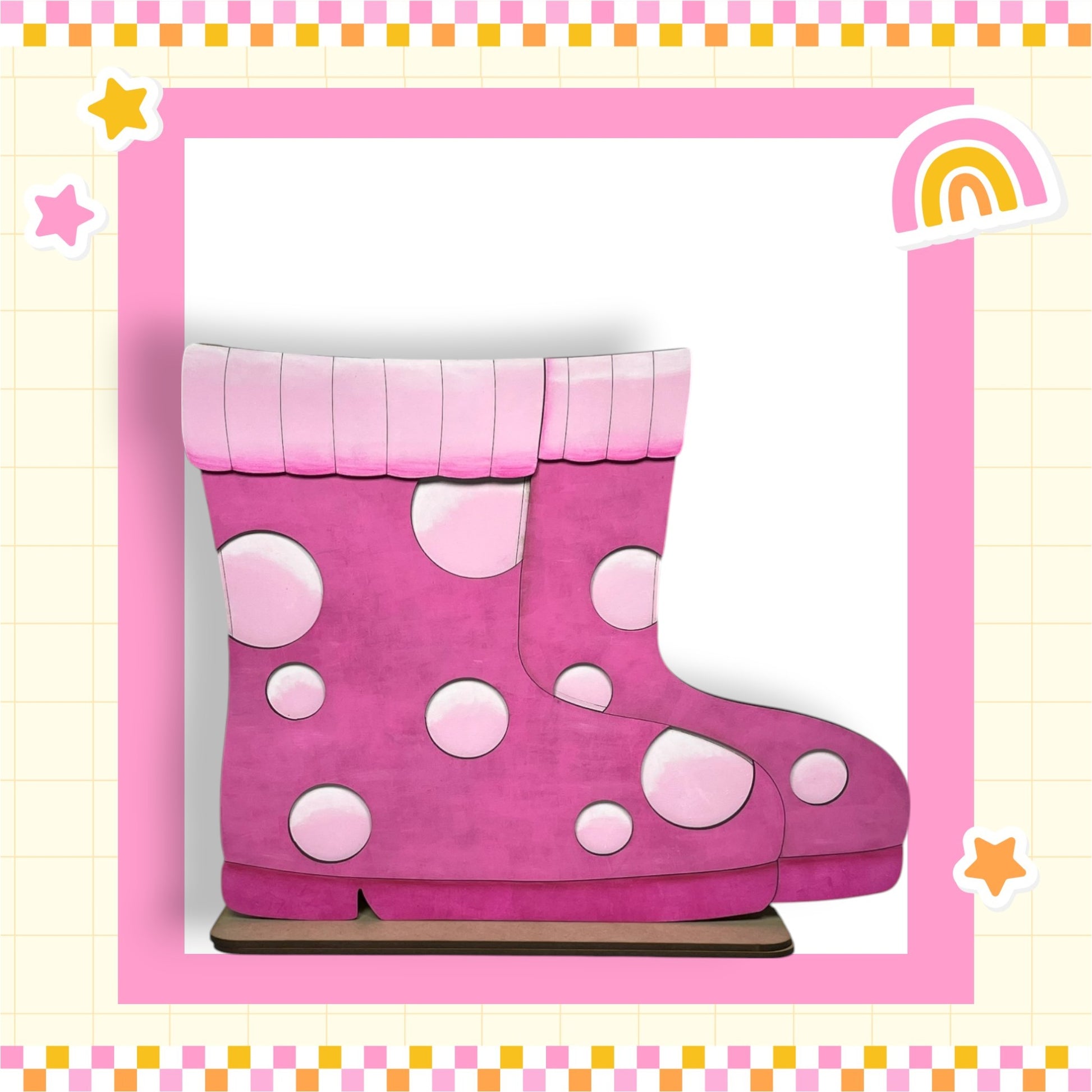 A pair of pink rain boots with white polka dots, set against a pink and yellow checkered background with a rainbow and stars.