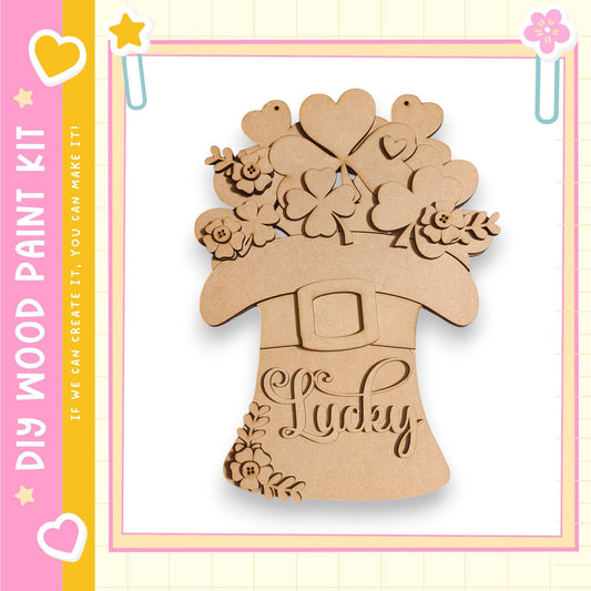 A wooden paint kit labeled "My Wood Paint Kit" with a decorative Easter-themed design featuring a cloverleaf pattern and the word "Lucky" on a brown background.