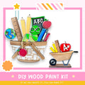 a DIY wood paint kit with various school supplies, including a basket filled with pencils, books, and an apple, as well as a smaller wooden cart with a red apple on top. The kit appears to be made of wood and is designed for children to create their own educational materials.
