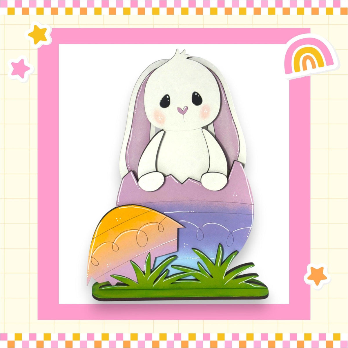 a picture of a white bunny sitting on top of a piece of paper