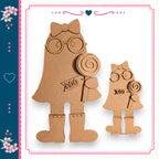 two cardboard cutouts of girls, one larger and one smaller, both wearing glasses and holding lollipops.