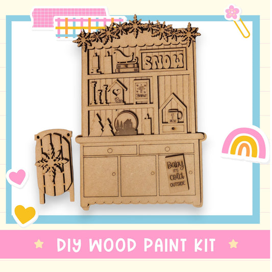a DIY wood paint kit, including a wooden cabinet with various decorative elements such as snowflakes, hearts, and a rainbow.