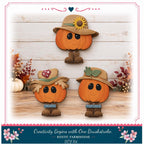 three wooden pumpkins with faces, each wearing a hat, arranged on a wooden surface against a white background.