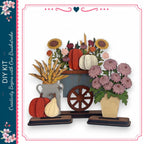 a DIY kit with a wooden wagon and various fall-themed decorations, including pumpkins, sunflowers, and chrysanthemums.