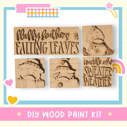 The image is a DIY wood paint kit featuring a collection of wooden cutouts with text and illustrations related to fall and winter themes.