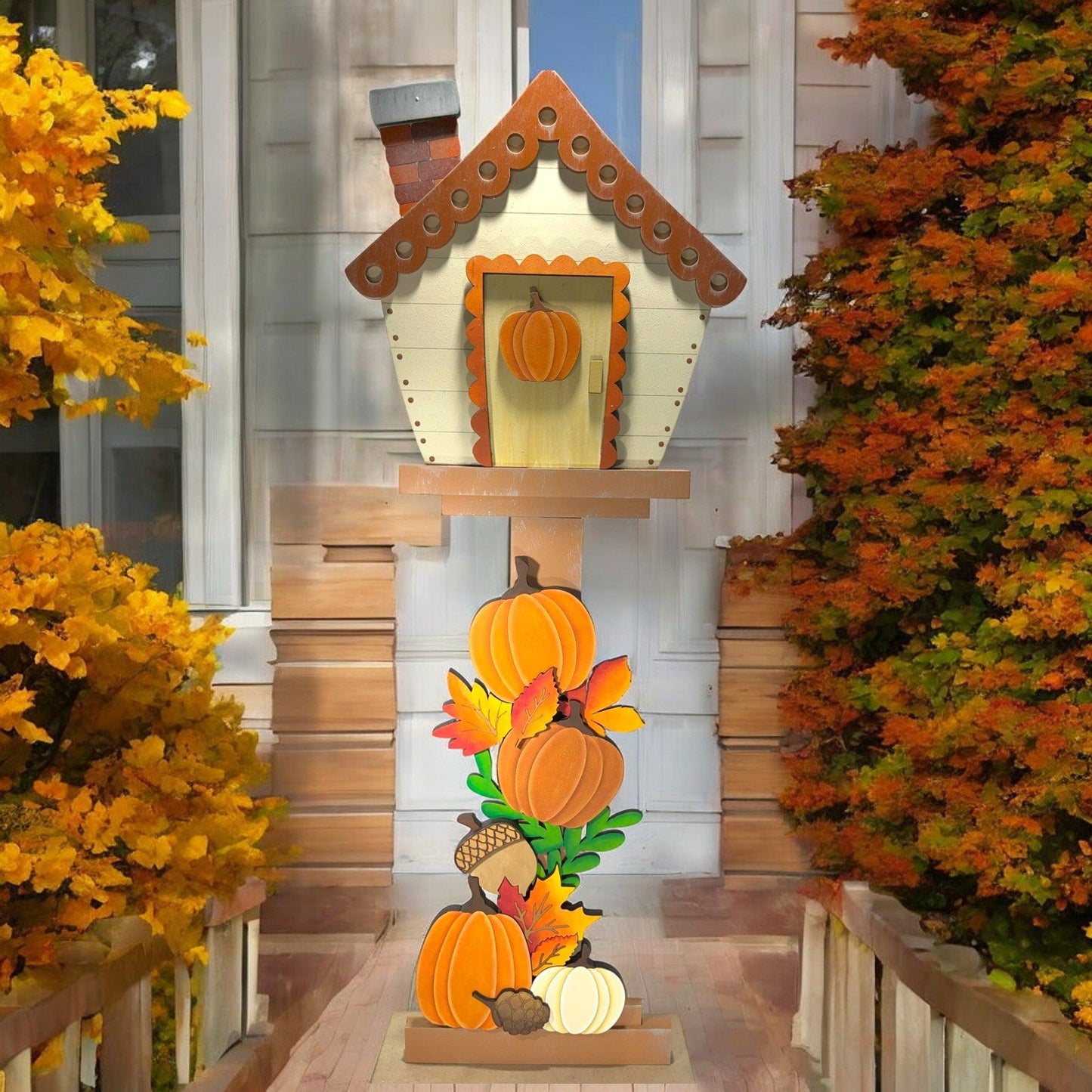 a house decorated with pumpkins and a birdhouse