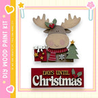 a wooden moose figure holding a gift box and a Christmas tree, with the text "DAYS UNTIL CHRISTMAS" displayed below.