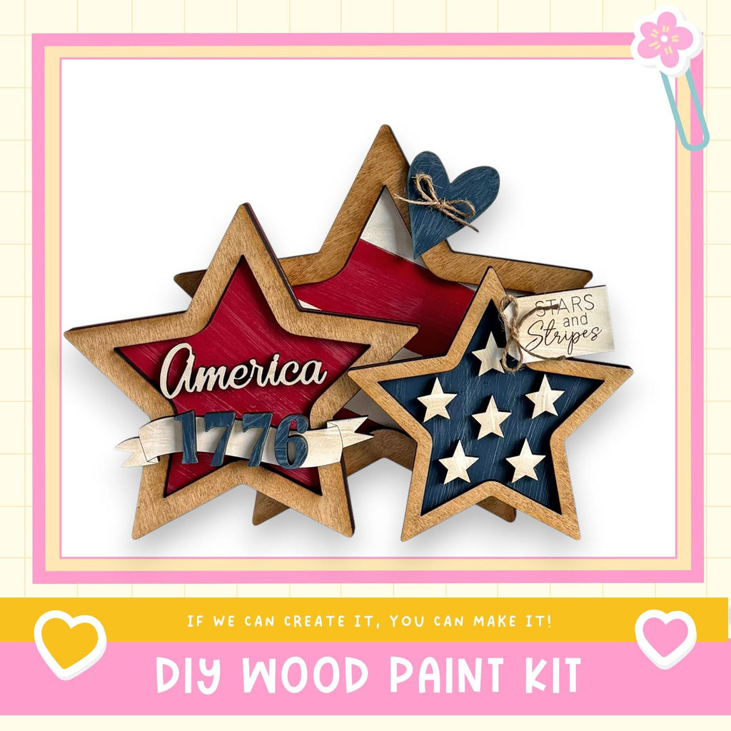 The image is a DIY wood paint kit featuring a wooden star-shaped decoration with the word "America" written on it, along with a heart-shaped decoration. The kit appears to be made of wood and is designed for creating similar star-shaped decorations.
