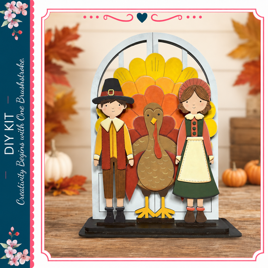 A DIY kit featuring a turkey, a boy in a red and yellow outfit, and a girl in a green dress, all posed in front of a wooden background with autumn leaves.