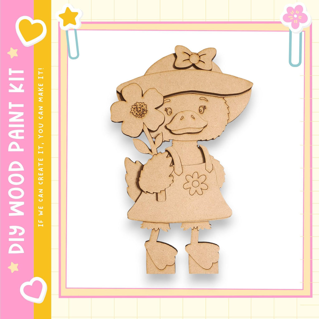 A wooden cutout of a cartoon duck holding a flower, set against a pink and yellow background with decorative elements.