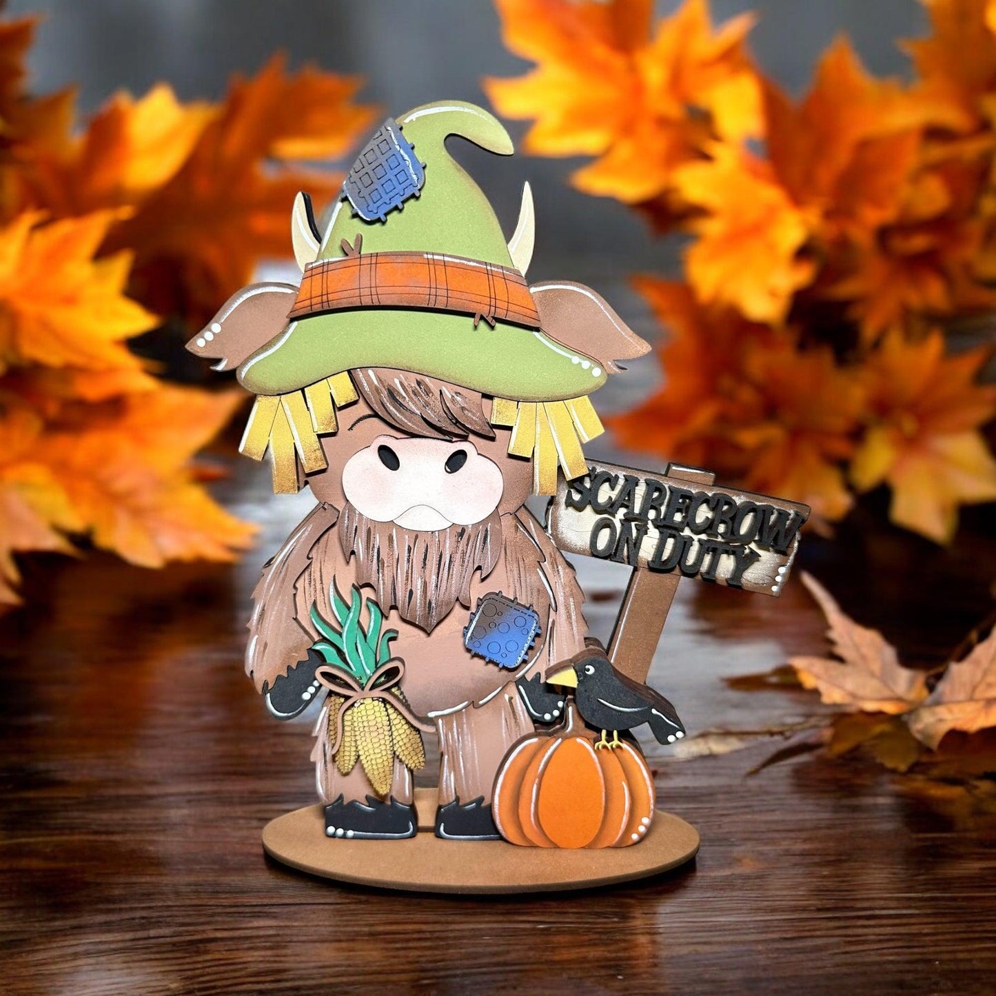 a small figurine of a scarecrow holding a sign