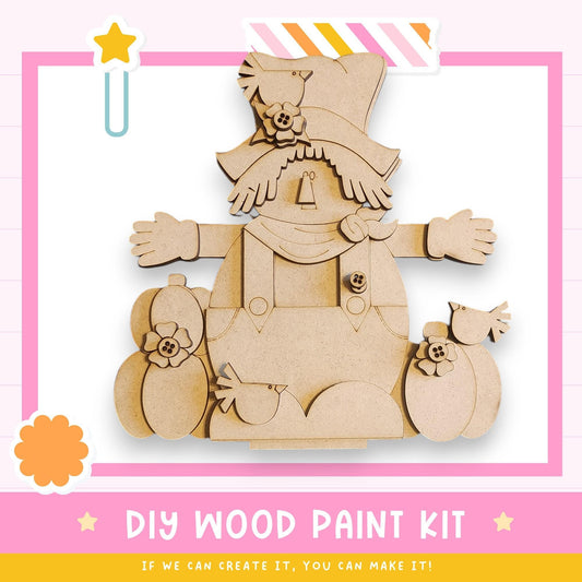 The image is a DIY wood paint kit featuring a wooden doll with a hat and flower decorations.