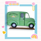 a green toy truck with a rainbow in the background