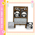 The image is a DIY paint kit featuring a skeleton-themed decoration with the words "HOME" and "Love Candy" displayed.