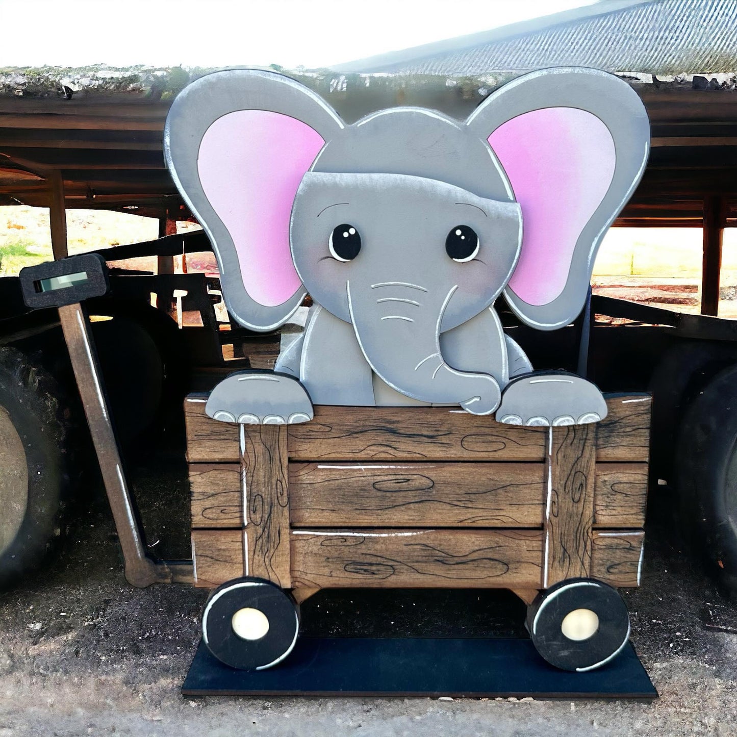 a toy elephant sitting in a wooden crate