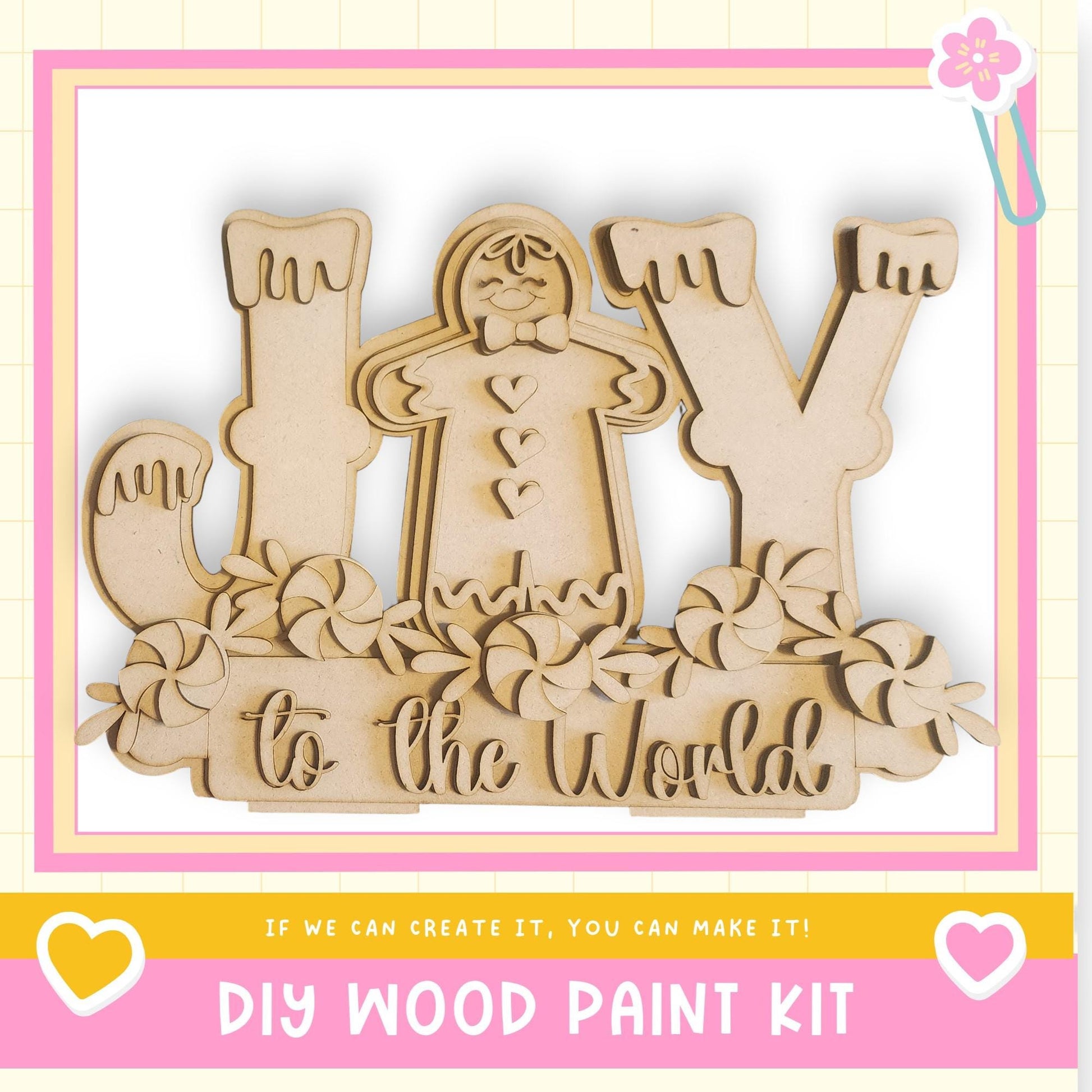 The image is a DIY wood paint kit featuring a wooden gingerbread man and the phrase "to the world" written on it.