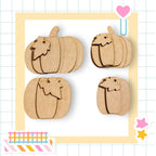 four wooden pumpkins arranged in a square frame, with a heart and stars decorating the border.