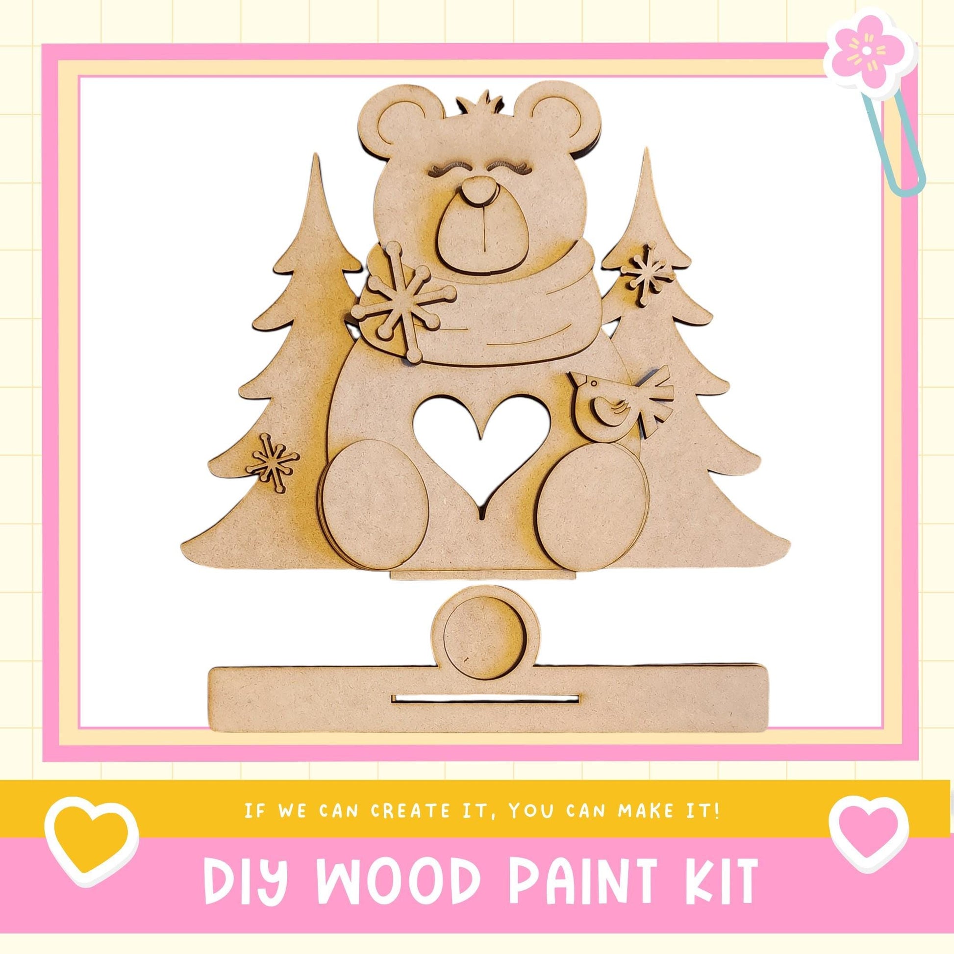 a DIY wood paint kit, with a wooden bear figure and pine trees as the main decorative elements.