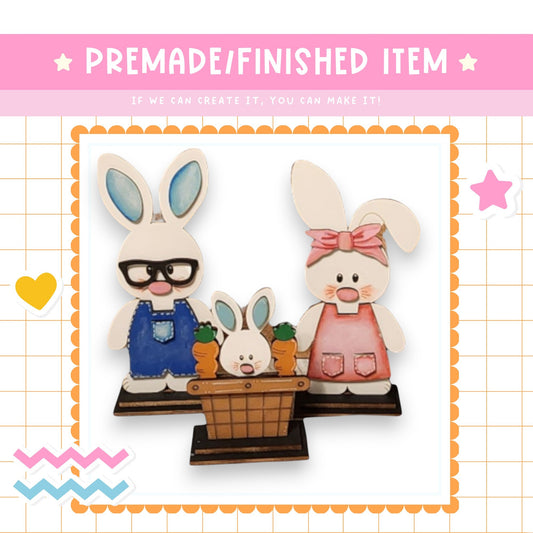 a picture of a couple of rabbits with a basket of carrots