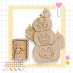 a Halloween-themed scene with three carved pumpkins and a small wooden door.