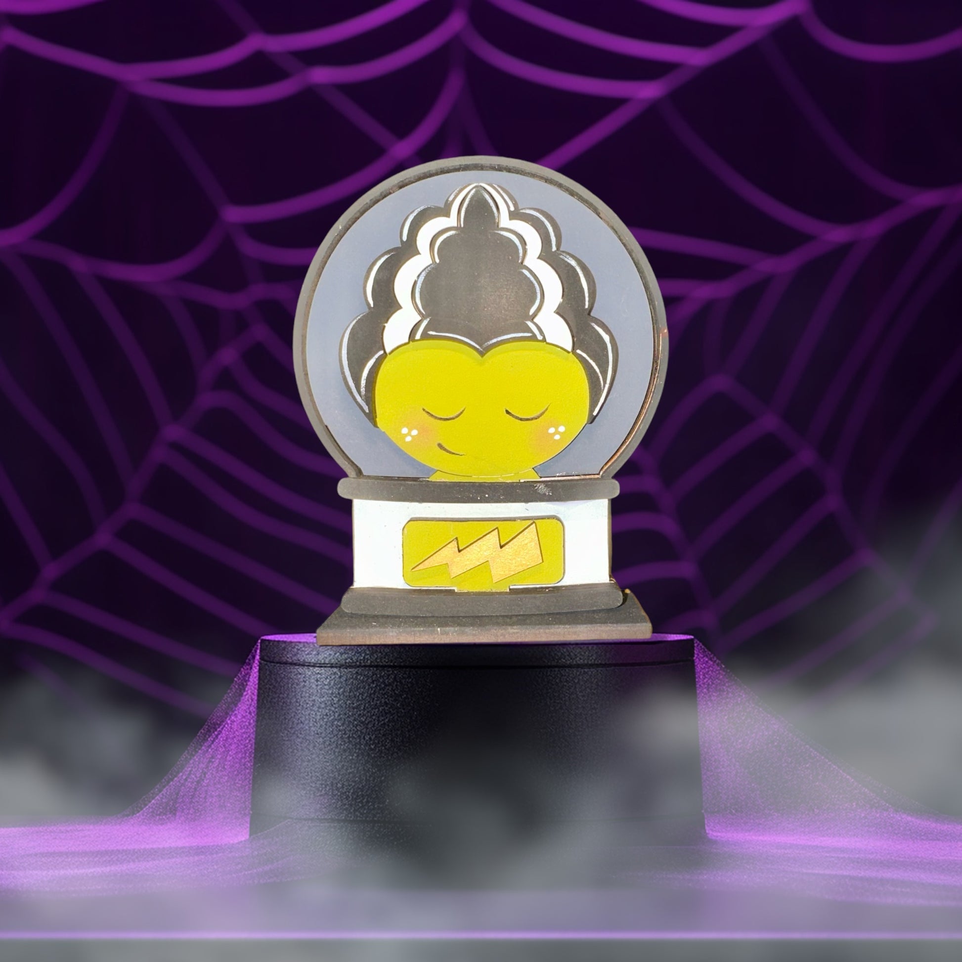 A whimsical, cartoonish illustration of a character with a yellow face and a black hairpiece, set against a purple background with a spider web pattern.