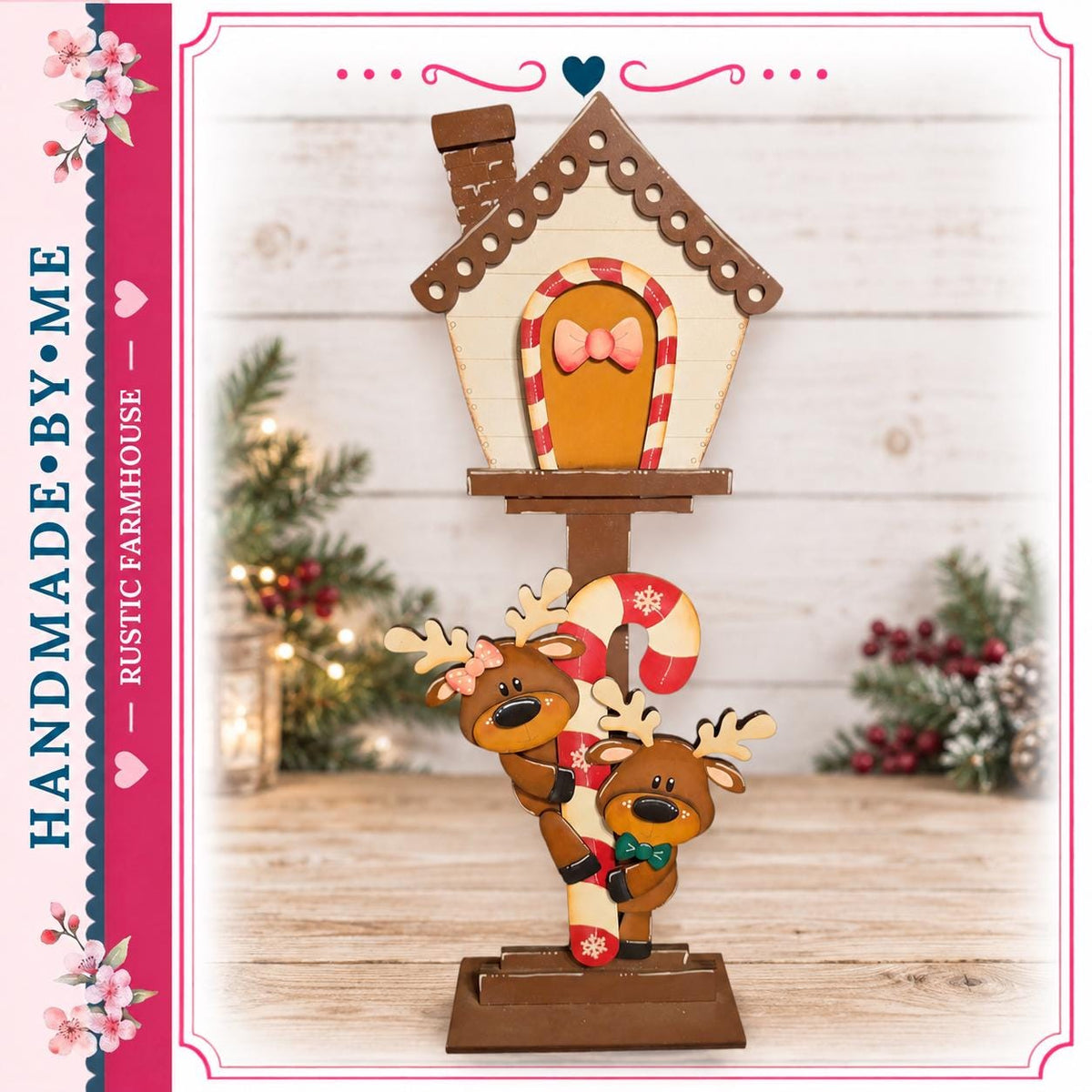 A hand-made wooden mailbox with a gingerbread house and reindeer decorations, set against a backdrop of Christmas trees and holiday decorations.