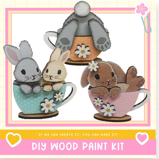 three cute cartoon rabbits sitting in teacups, each with a flower decoration.