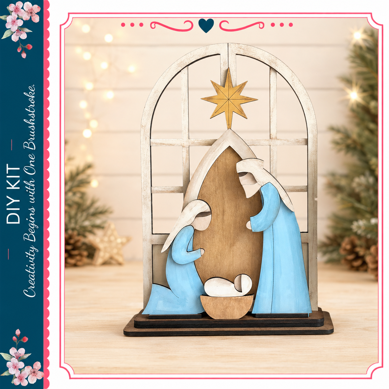 A wooden nativity scene with a baby in a basket, featuring two figures dressed in blue robes, set against a backdrop of a window and pine trees.
