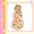 A wooden ornament kit with a snowman design, featuring three wooden balls stacked on top of each other with decorative elements.
