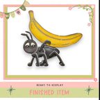 a cartoon ant carrying a banana on its back.