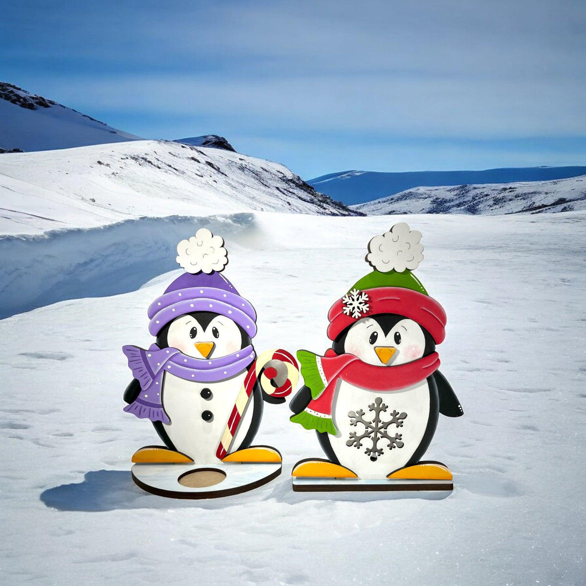 a couple of penguins that are standing in the snow