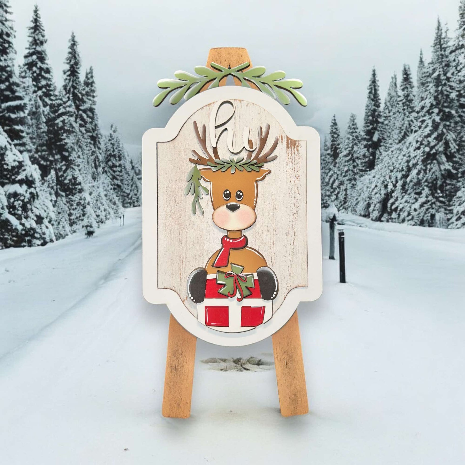 a wooden sign with a picture of a reindeer on it