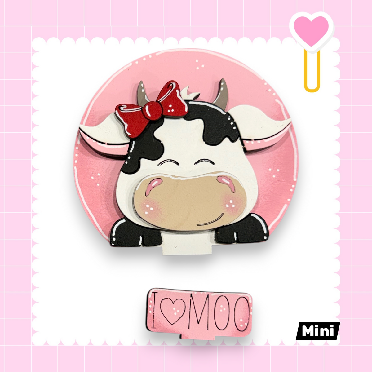 A cute cartoon cow with a bow on its head, surrounded by a pink background with a heart and a pink heart-shaped object.