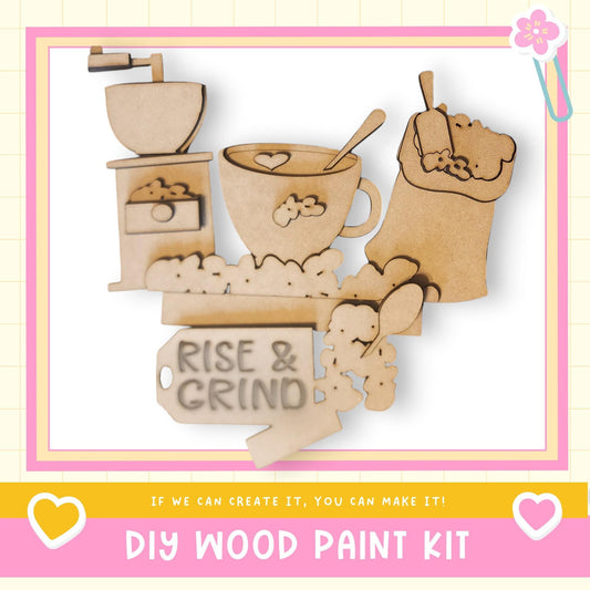 The image is a DIY wood paint kit advertisement, featuring various wooden shapes and objects such as a coffee cup, spoon, and bowl, along with the text "RISE & GRIND" and "DIY WOOD PAINT KIT" displayed prominently.