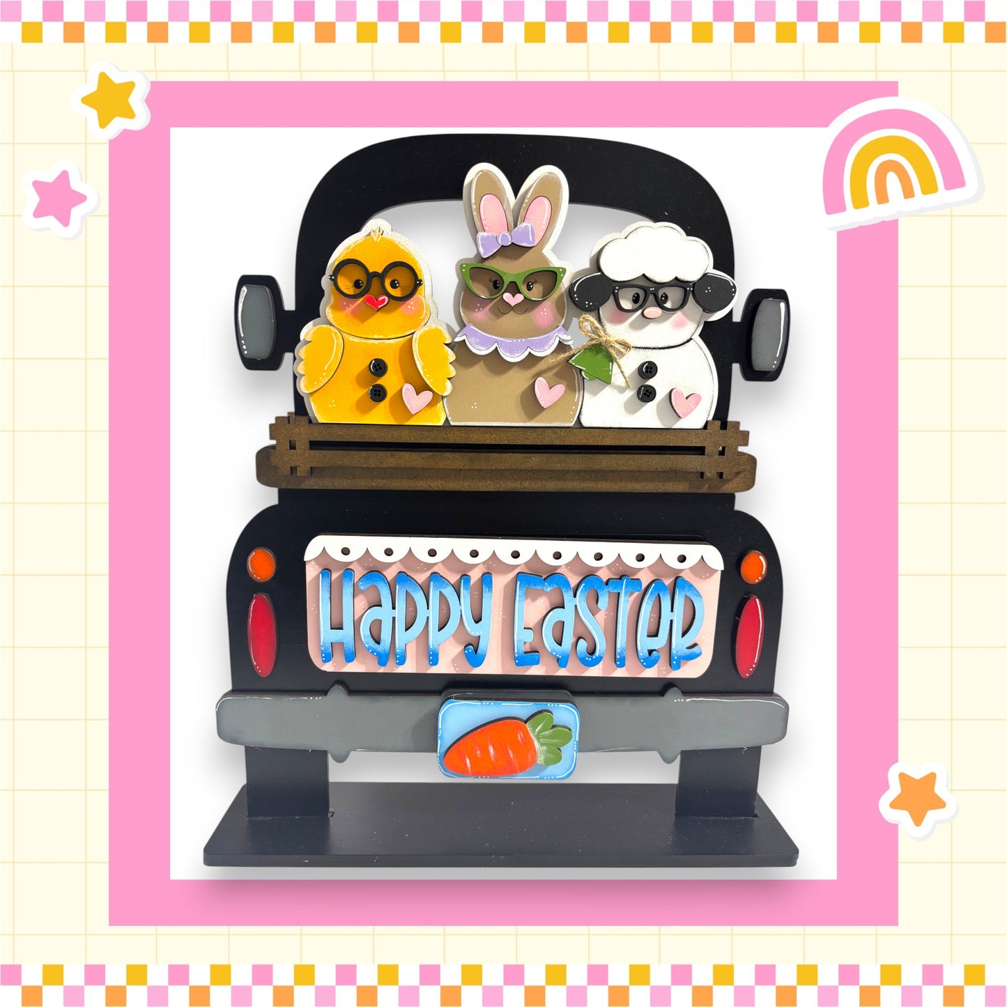A black truck with a wooden bed, decorated with Easter-themed stickers of a yellow chick, a white bunny, and a brown sheep. The truck has a sign that says "Happy Easter".
