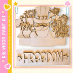 The image is a wooden paint kit featuring a patriotic design with a santa claus, fireworks, and the word "FREEDOM".