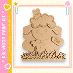 a wooden craft kit, specifically a sheep-shaped piece, with a cloud-shaped head and a flower-shaped body. The kit appears to be made of wood and is designed for children to create their own sheep-themed items.