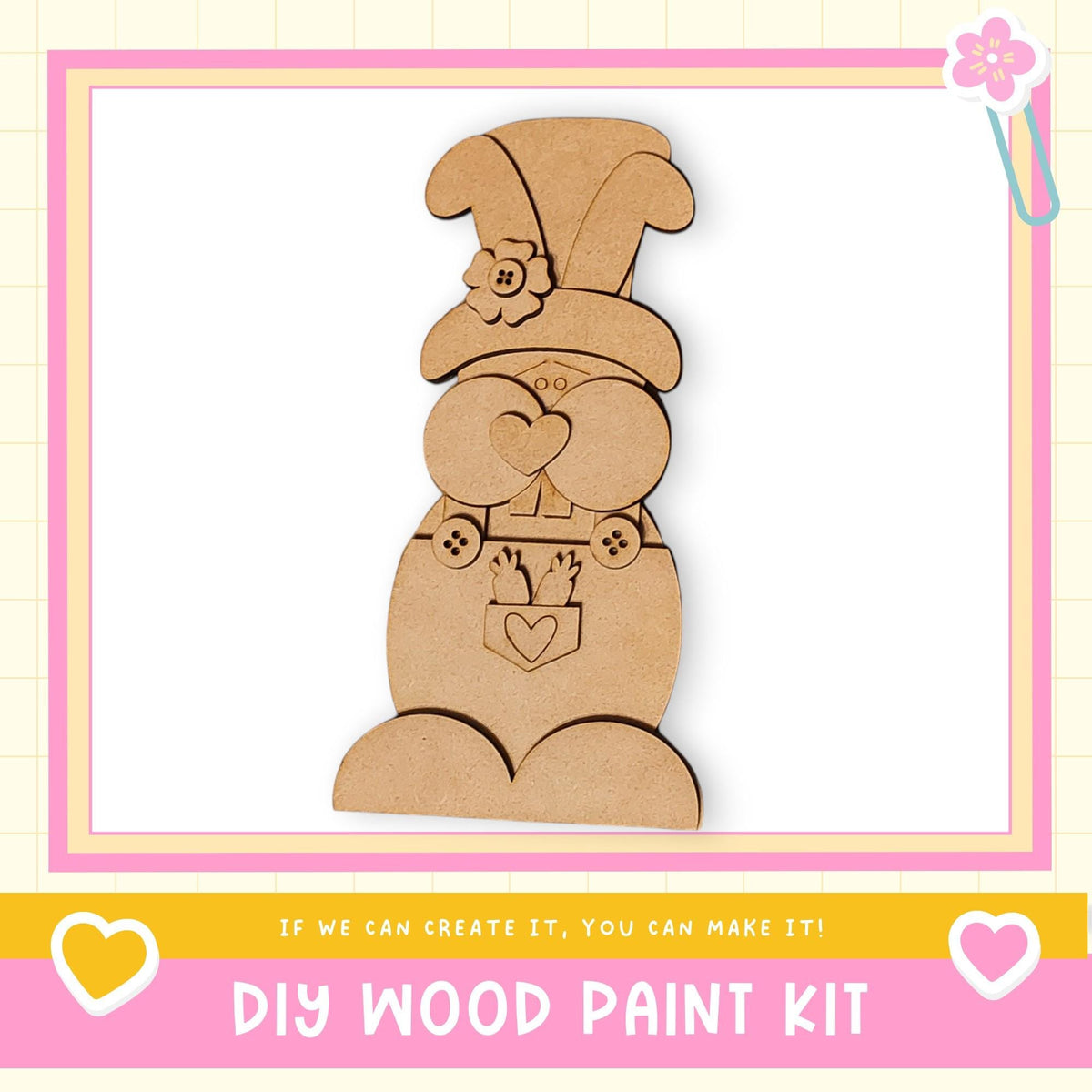 a DIY wood paint kit, with a wooden gnome figure as the main focus. The gnome is wearing a hat with a flower and has a heart-shaped bow around its neck. The kit appears to be made of wood and is designed for creating wooden figures.