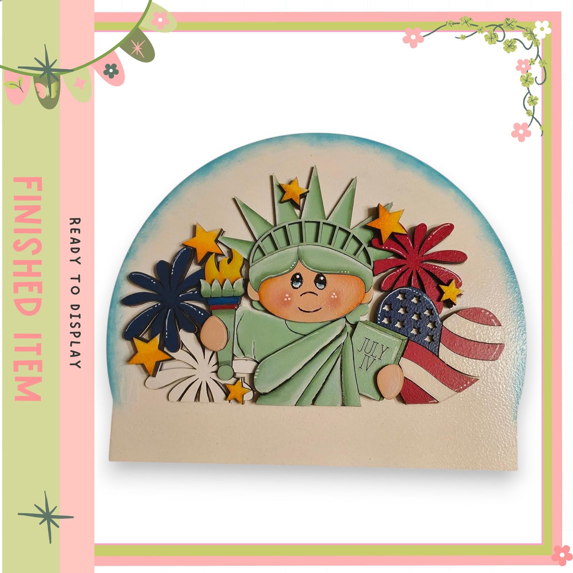 A wooden puzzle depicting the Statue of Liberty surrounded by various patriotic symbols, including fireworks and American flags.