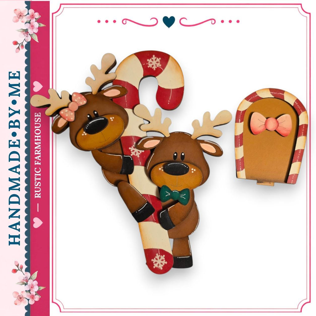 a pair of wooden reindeer with bows, a candy cane, and a small wooden door, all set against a white background.