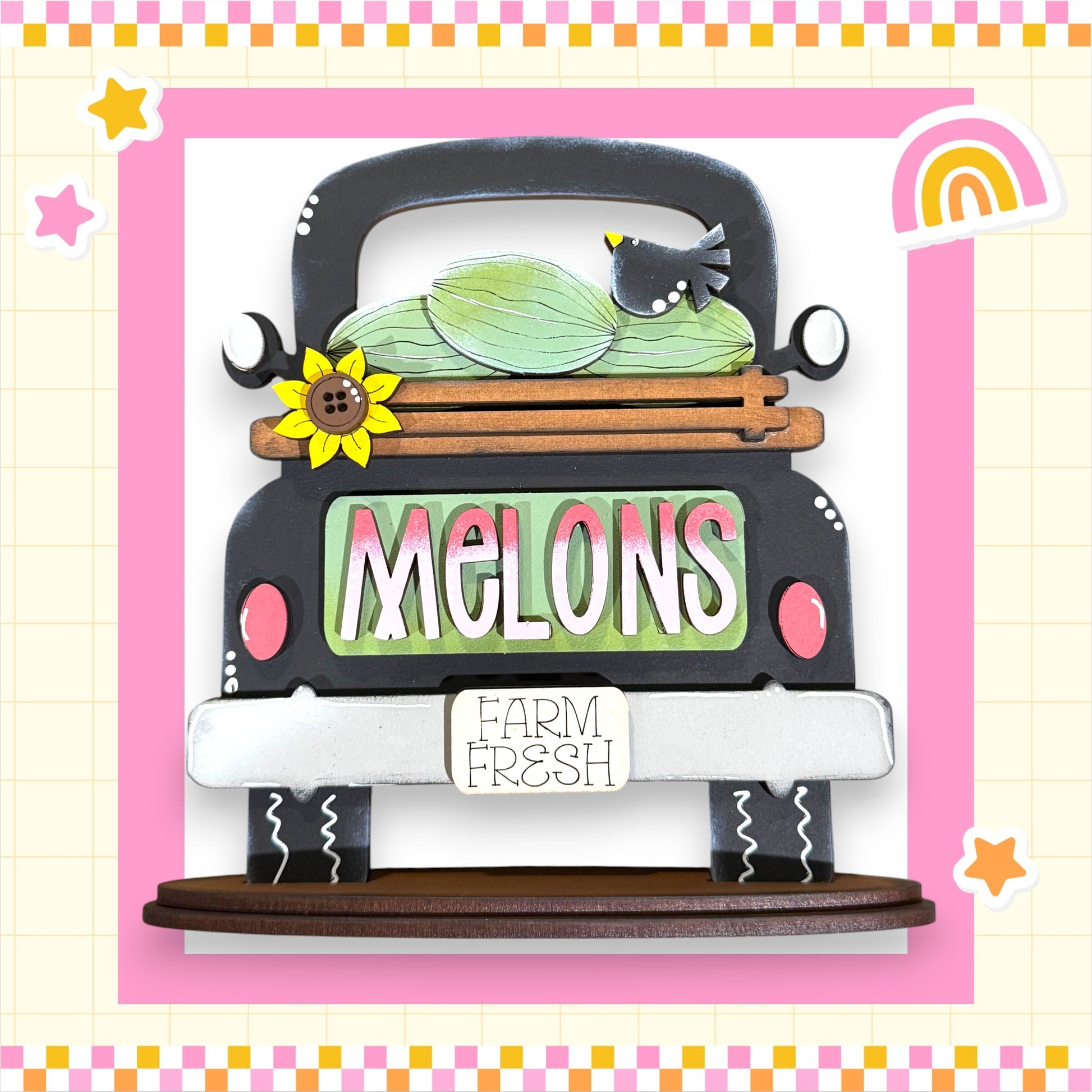 A wooden truck with a melon on the back, surrounded by a pink and white checkered border and a rainbow. The word "Melons" is displayed on the truck, and there is a sign that says "Farm Fresh".