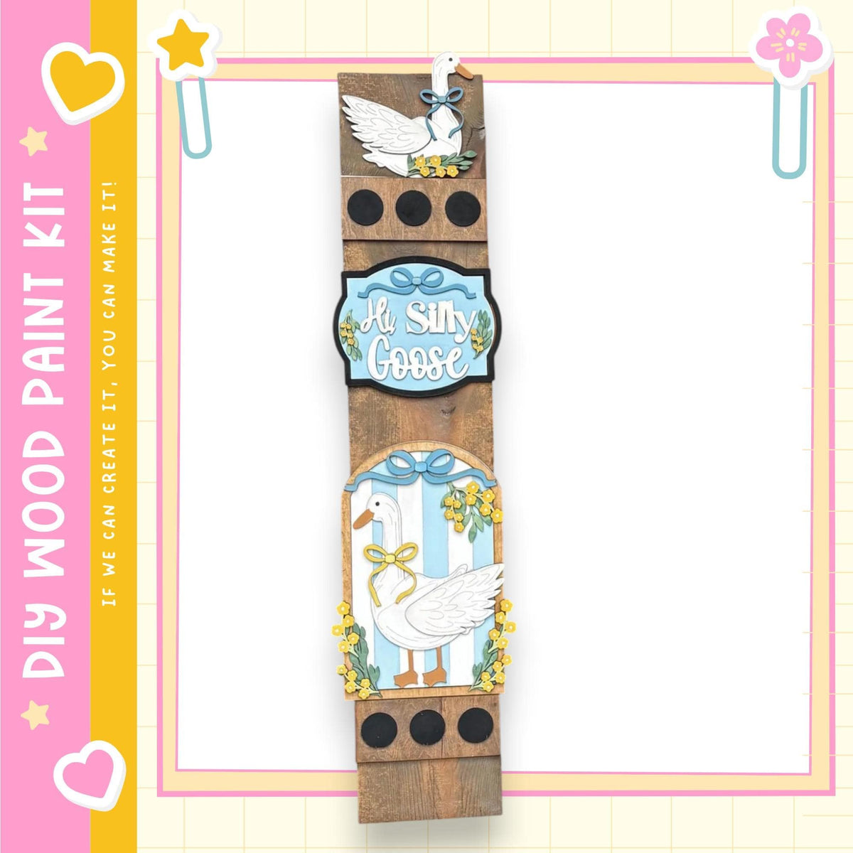 The image is a wooden frame with a decorative border, featuring illustrations of a white goose and flowers. The frame is set against a pink and yellow background with decorative elements such as hearts and stars.