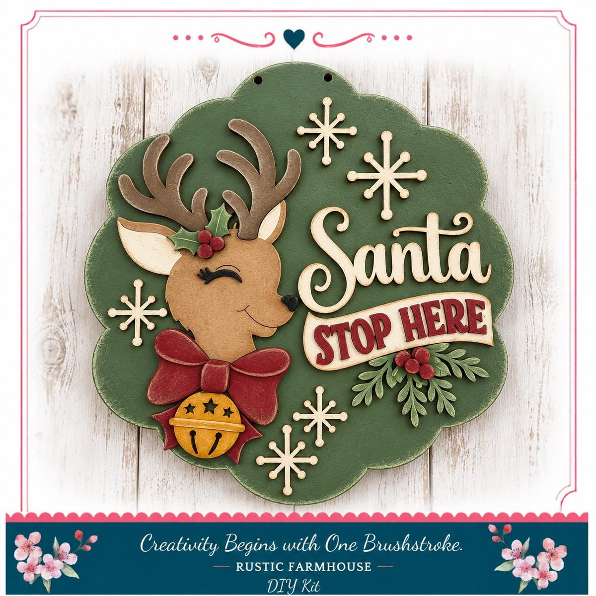 A decorative Christmas wreath with a Santa Claus head, a bell, and snowflakes. The wreath has the text "Santa STOP HERE" written on it.