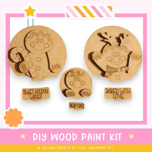The image is a promotional poster for a DIY wood paint kit, featuring three wooden shapes resembling cookies or candies with various designs and text.