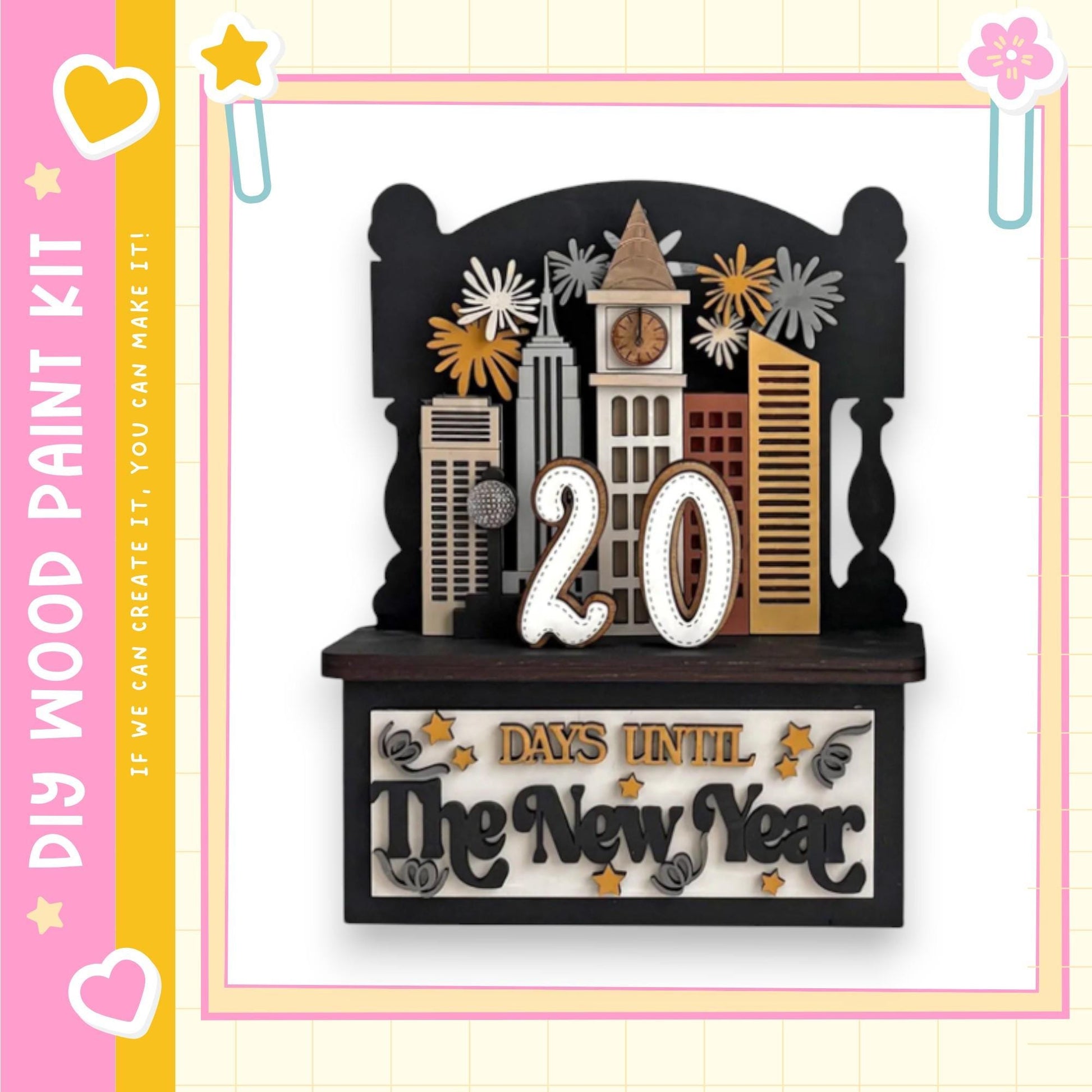 A decorative wooden frame with a city skyline and fireworks, along with the text "20 DAYS UNTIL The New Year" and a heart symbol.