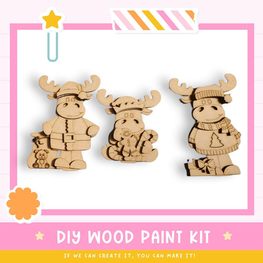 three wooden toy animals, likely moose or reindeer, posed in a playful manner. The text below the image suggests that it is a DIY wood paint kit, and if the viewer can create it, they can make it.